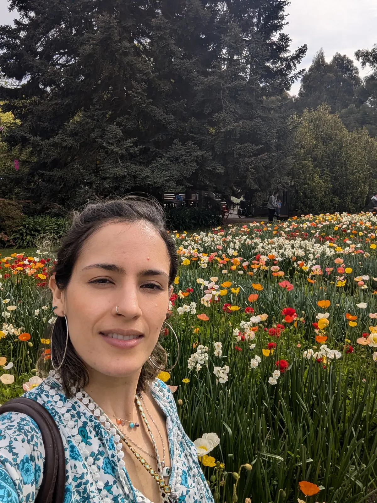 Laura Arango in a garden of colourful flowers